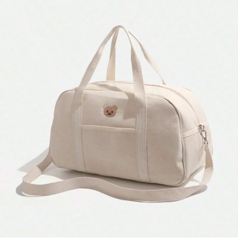 Sac à langer beige vu de côté avec bandoulière ajustable