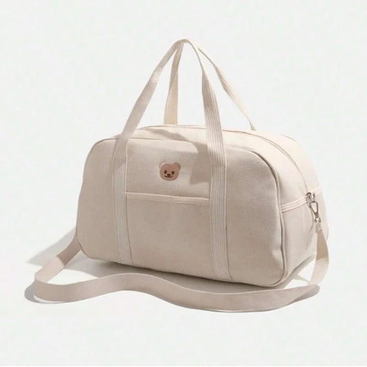 Sac à langer beige vu de côté avec bandoulière ajustable